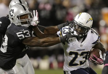 Northwestern football alum Nick Roach takes down San Diego's Ronnie Brown for one of his 12 tackles Sunday night.  (AP Photo/Ben Margot)