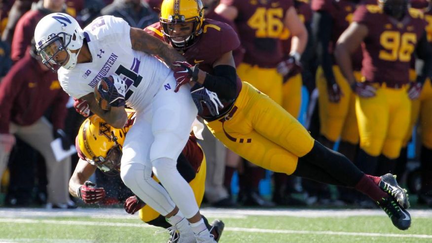 Kyle Prater caught this pass in front of Minnesota's Damarius Travis, but Prater had a key drop on fourth down and Travis intercepted a late Hail Mary as the Gophers beat Northwestern. Photo credit: Ann Heisenfelt, AP